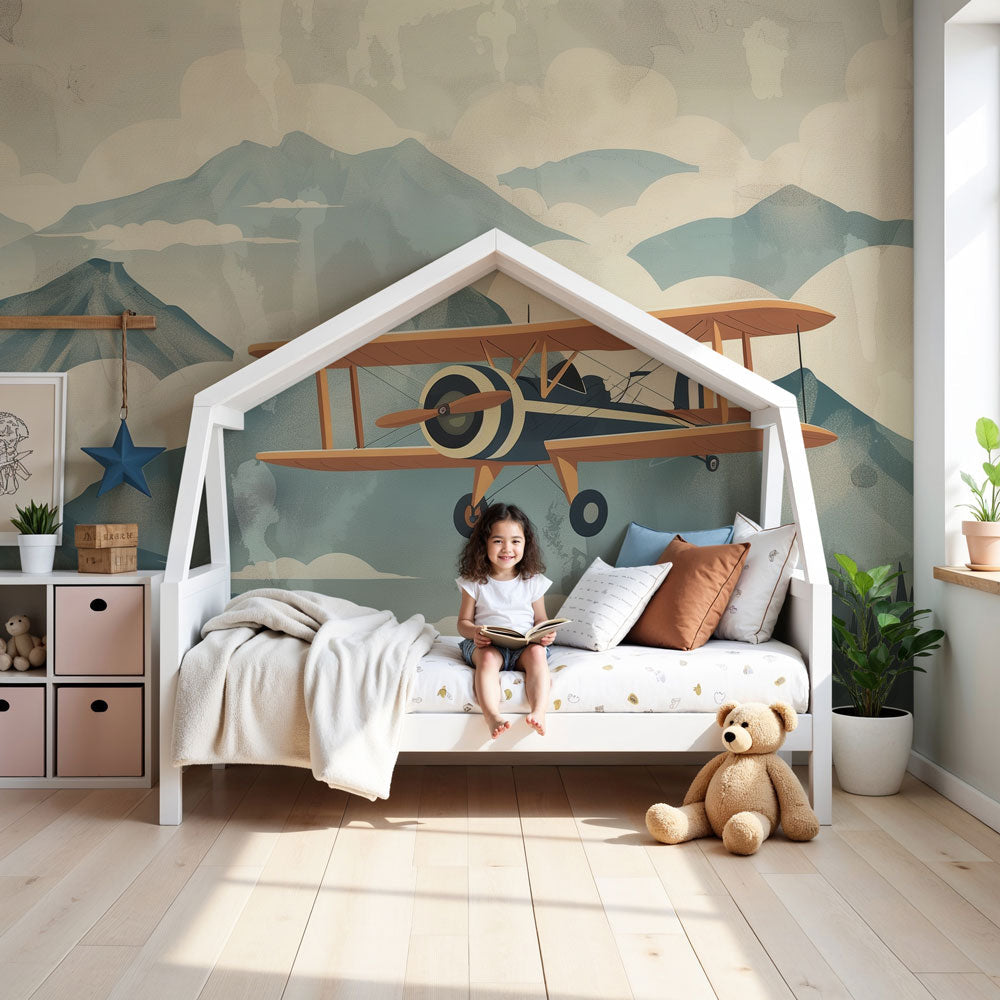 Kids-Mundo vintage biplane mountain wall mural in a calm nursery with a cot and soft neutral decor