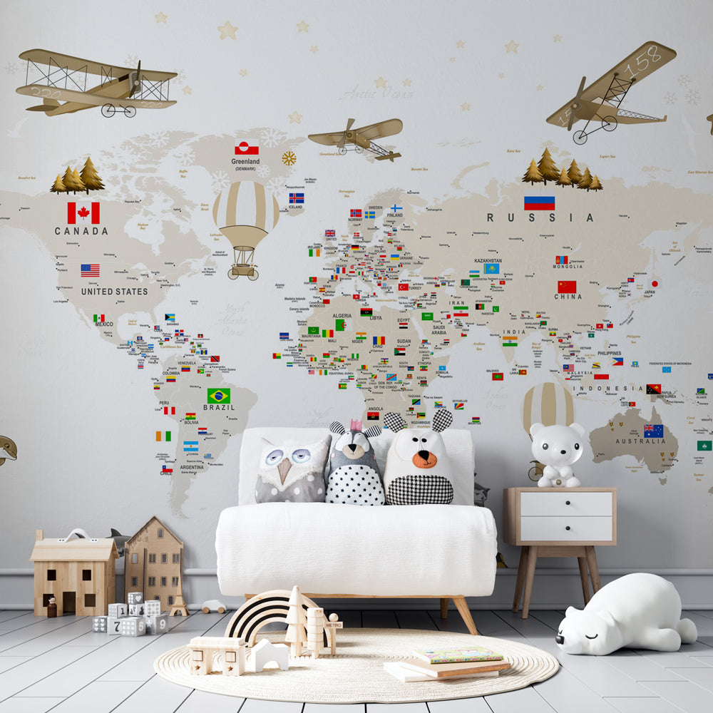 Kids-Mundo vintage travel world map wall mural in a playroom, showing flags, balloons and ocean animals