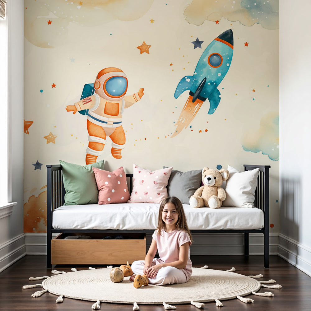Kids-Mundo watercolour astronaut and rocket wall mural above a cot in a cream nursery.
