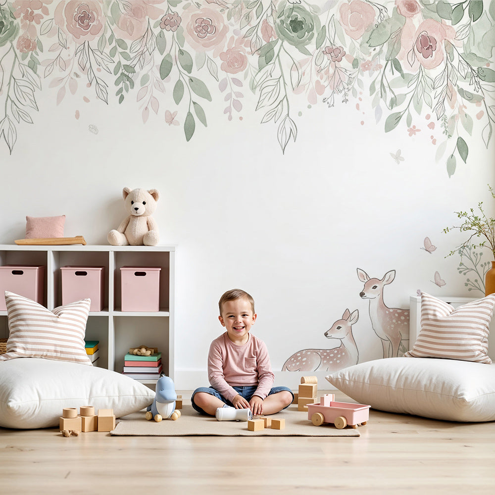Kids-Mundo watercolour fawn and blush floral wall mural styled in a soft pastel nursery behind a cot