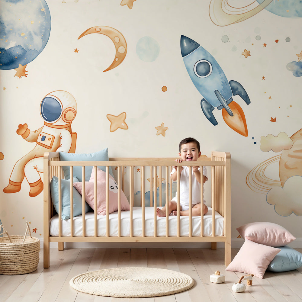 Kids-Mundo waving astronaut watercolour wall mural above a cot in a cream nursery.