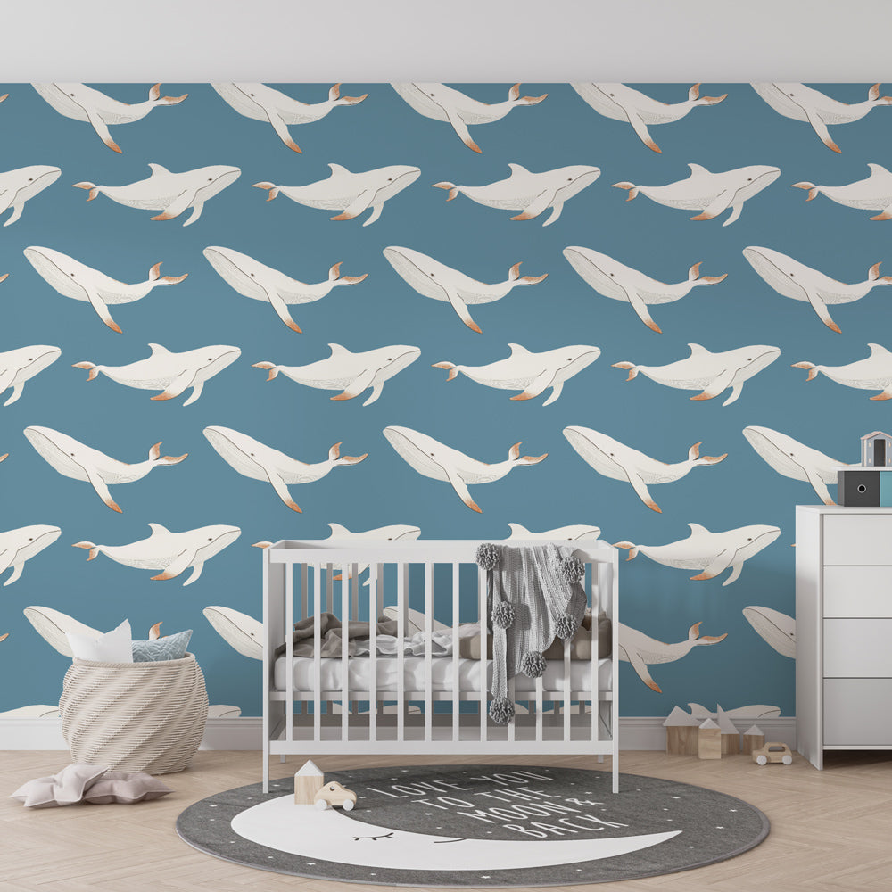 Ocean theme whale mural wallpaper showcased in calming blue kids room interior