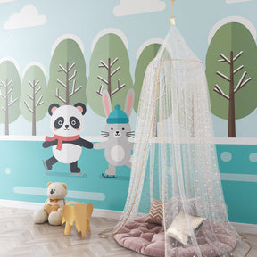 Charming winter scene mural wallpaper featuring skating animals in bright children's playroom