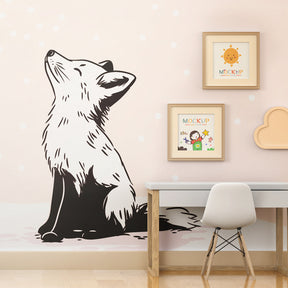 Black and white fox mural wallpaper behind cozy reading corner in kids room