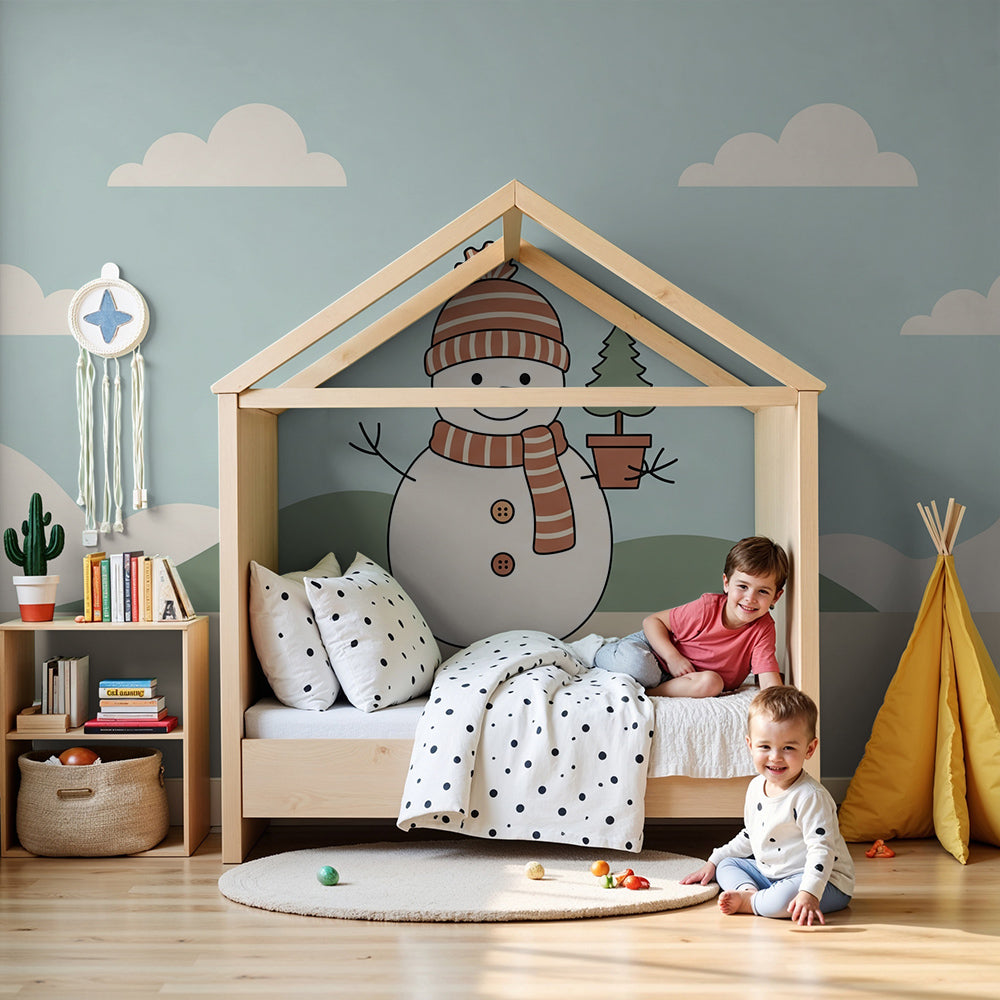 Kids-Mundo snowman wall mural with a fir tree styled in a pastel nursery room