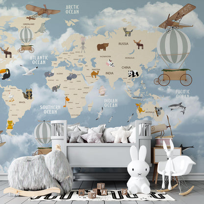 Kids-Mundo adventure world map wall mural behind a bed in a bright kids bedroom