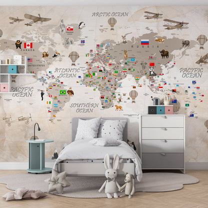 Kids-Mundo world map wall mural with country flags and animals shown in a children's bedroom