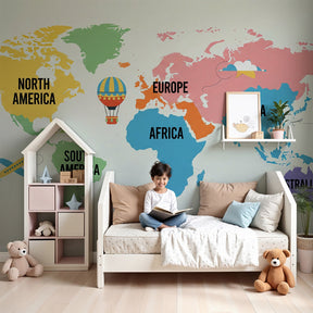 Colorful world map mural wallpaper with planes and balloons in modern kids bedroom by Kids-Mundo